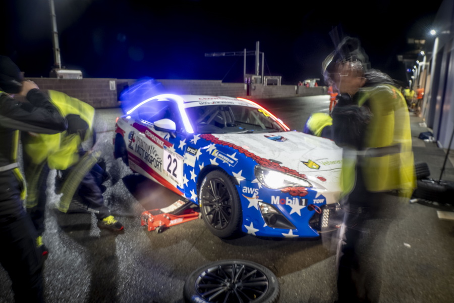 Race car pit stop at night.