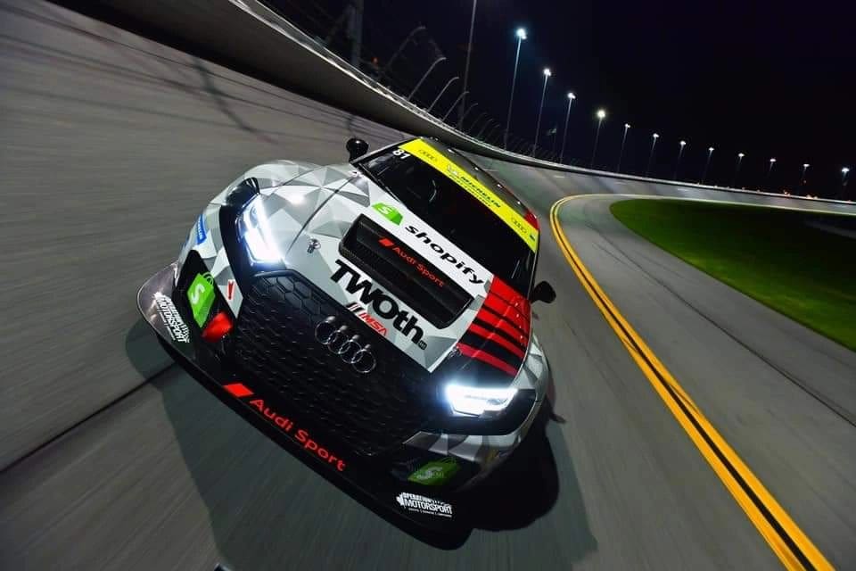 Audi race car on night track.