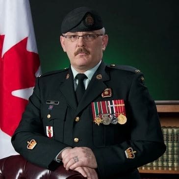 Here's an alt tag for the image: Canadian Army officer in formal uniform.