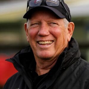 Smiling man wearing Operation Motorsport jacket.