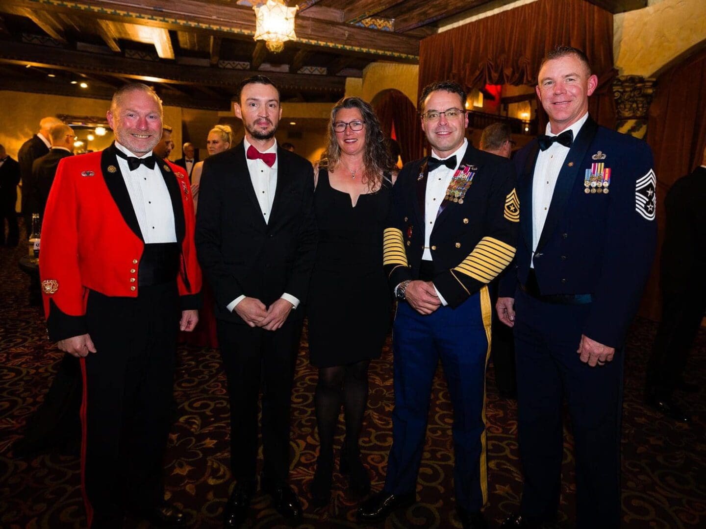 Four men in formal attire at a gala.