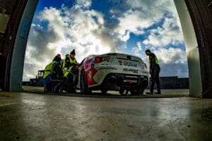 Race car being prepped by crew.