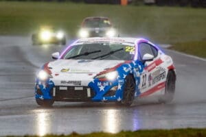 Race car with American flag design on a track.