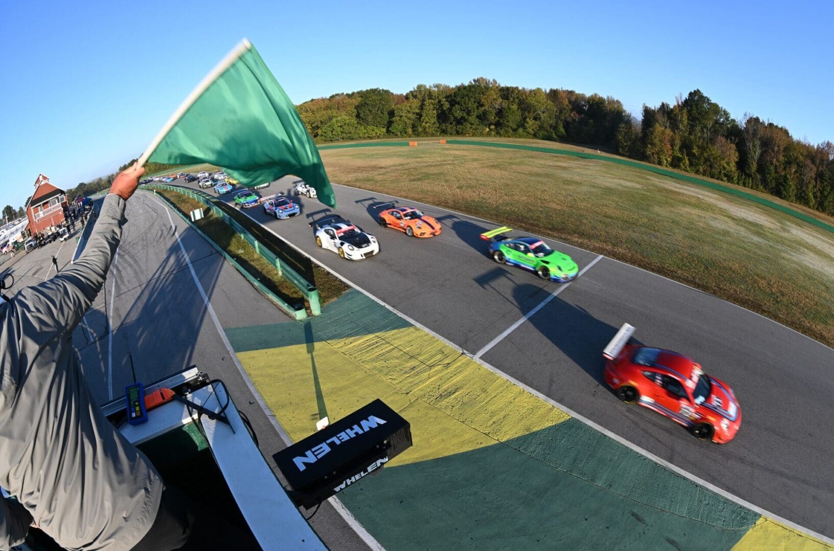 Race cars speeding on a track.