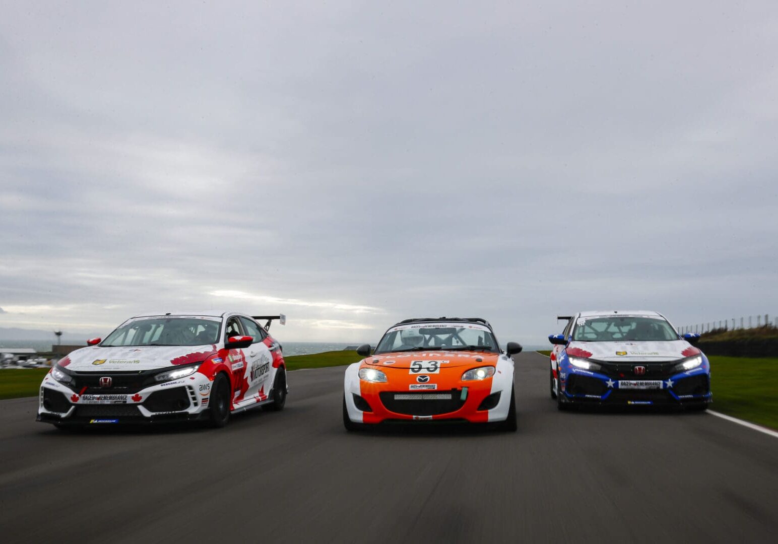 Three race cars on a track.